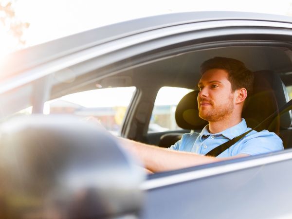 Happy Man Driving a Rental Car